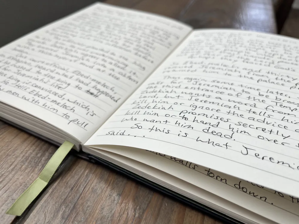 open journal resting on a wooden bench